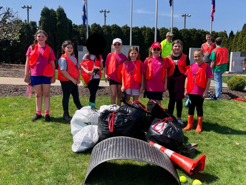 Girl Scouts picking up trash and litter.